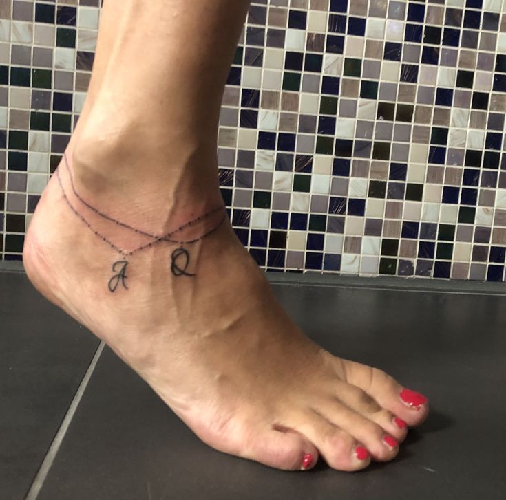 a woman's foot with a small tattoo on the ankle that reads, love