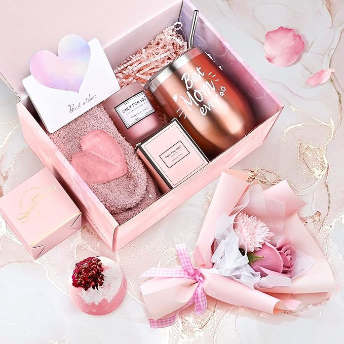 a pink gift box filled with personal care items and flowers on top of a table