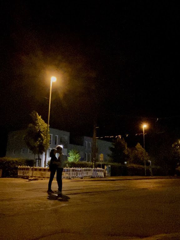 a man riding a skateboard down a street at night with no one on it