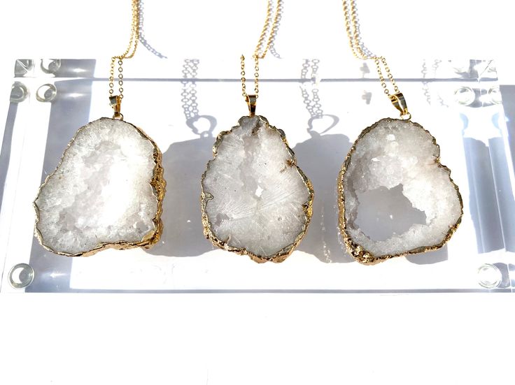 Natural quartz crystal geode necklace. This necklace features a 24k gold plated brass chain along with a stunning, natural gold plated quartz crystal geode. Quartz cleanses and purifies any space or object and it also raises the vibration and manifestation abilities either of its wearer, or of other natural stones. *Please note we have a small batch of these, and they are all gorgeous - but each is unique. So yours will be a little different than the picture, but wonderful - we guarantee it or y Gold Jewelry With Large Stone For Gift, Gold Geodes With Natural Stones As Gift, Gold Gemstone Crystal Necklace For Wedding, Gold Crystal Necklaces With Natural Stones For Wedding, Gold Crystal Gemstone Necklace For Wedding, Healing Gold Necklaces With Raw Stone, Raw Stone Geodes In Mineral Crystal As Gift, Spiritual Gold Necklace With Raw Stone, Gold Necklace With Raw Stone