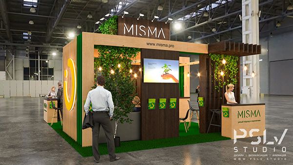 a man and woman standing in front of a booth at an event with plants growing on it