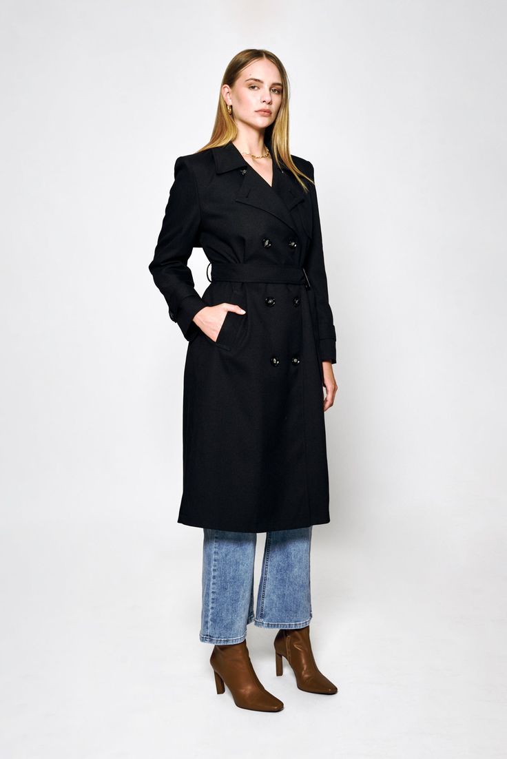 Step out in style with the Audrey Trench Coat by Lakeyo – the ultimate in sleek, sophisticated fashion.Crafted from a premium blend of 97% polyester and 3% spandex, this trench coat offers both style and comfort. The lightweight material makes it perfect for layering, while the tailored fit flatters your figure with a belted waist to accentuate your curves.Featuring a classic double-breasted front closure and a notched collar, the Audrey Trench Coat has a timeless, versatile look that never goes out of style. The premium material is both lightweight and durable, making it the perfect choice for any occasion.The Audrey Trench Coat by Lakeyo is available in a range of sizes, ensuring a perfect fit for any body type. Whether you're dressing up for a special event or simply running errands aro Solid Gabardine Pea Coat For Fall, Fitted Double-breasted Long Coat, Fitted Double-breasted Wool Coat For Spring, Fitted Wool Coat With Belted Cuffs For Fall, Spring Wool Coat With Belted Cuffs, Fitted Solid Double-breasted Outerwear, Fall Gabardine Long Coat, Fall Gabardine Outerwear With Hidden Button Closure, Fitted Solid Wool Coat With Belt