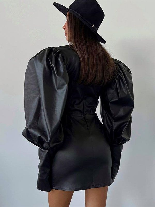 a woman in a black dress and hat is standing back to back with her hands on her hips