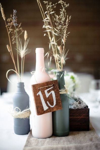 three vases with flowers in them are sitting on a table, one has a sign that reads 15