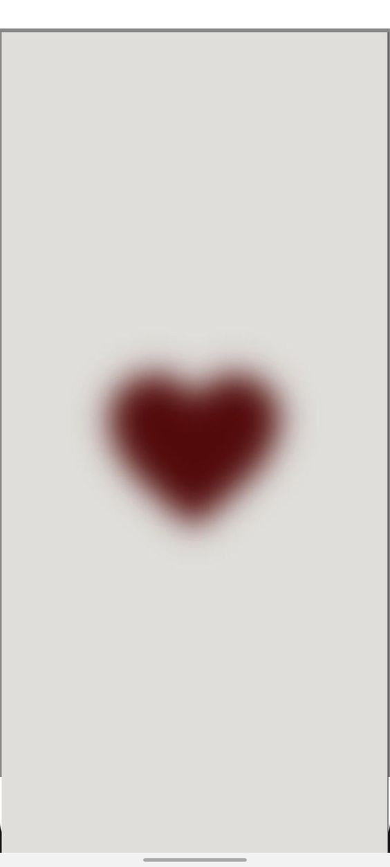 a heart shaped object is shown in the middle of an image with dark red paint on it