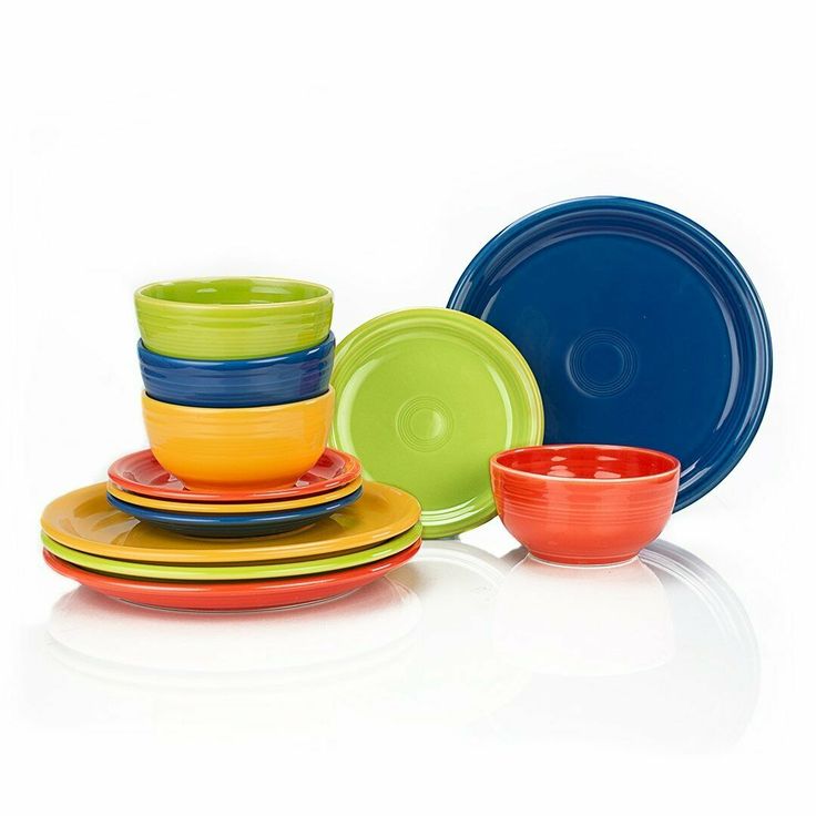 a stack of different colored plates and bowls