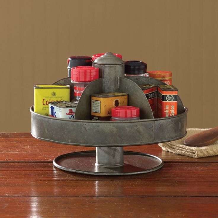 a metal tray with spices on top of a wooden table