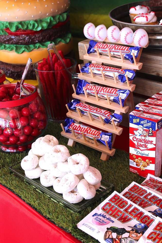 a table topped with lots of food and desserts on top of grass covered ground