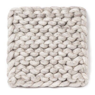 a white knitted blanket on a white background