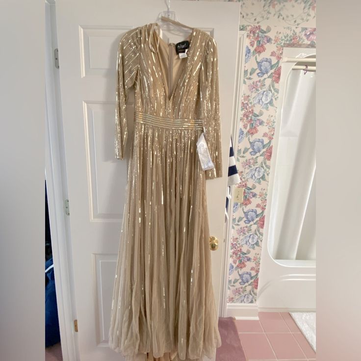 This Is A Mac Duggal Evening Gown Size 2 In Color Taupe. It Is Long Sleeves With No Slits. This Gown Has Never Been Worn Before. Picture Of Tag Still Being Attached For Proof That It Has Never Been Worn. Elegant Long Gold Dress, Champagne Maxi Dress For Gala, Glamorous Long Wedding Gown, Elegant Long Embellished Gown, Glamorous Long Evening Gown, Champagne Maxi Length Formal Gown, Champagne Maxi Gown For Formal Occasions, Embellished Long Dresses For Formal Occasions, Long Embellished Dresses For Formal Occasions