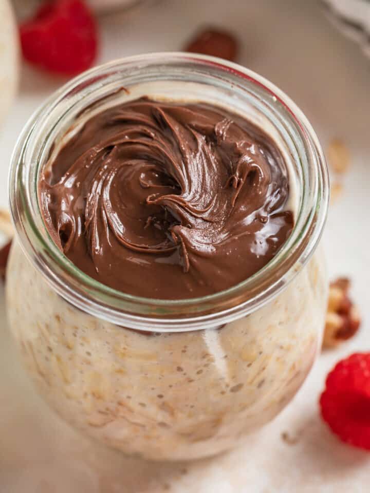 nutella overnight oats in a jar with chocolate frosting