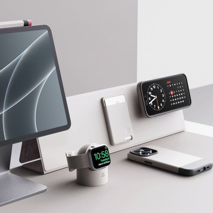 an apple watch and other electronic devices are on the table next to a computer monitor