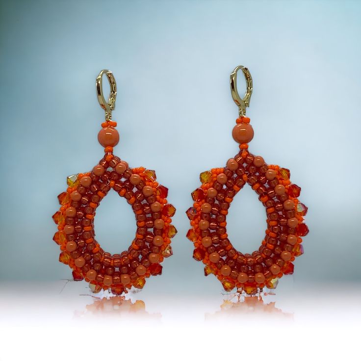 Beautiful beaded pearly drop earrings, they will brighten up your day! Swarovski pearls combined with shiny orange Swarovski crystals and high quality Japanese seed beads. These beaded earrings are unique, handmade statement earrings.  Finished with a stainless steel hypoallergenic leverback gold coloured earring. Each item I design is made with the best quality beads, accessories and materials and comes in a handmade embroidered jewellery bag. Total length: 6.6 cm Fall length: 5 cm Width: 3.3 cm Depth: 8mm Weight (per pair): 14 gr Other colour variations are available in my shop. Embroidered Jewellery, Beautiful Beaded Jewelry, Jewellery Bag, Beads Accessories, Drop Beads, I Design, Swarovski Pearls, Jewelry Bags, Beaded Earrings