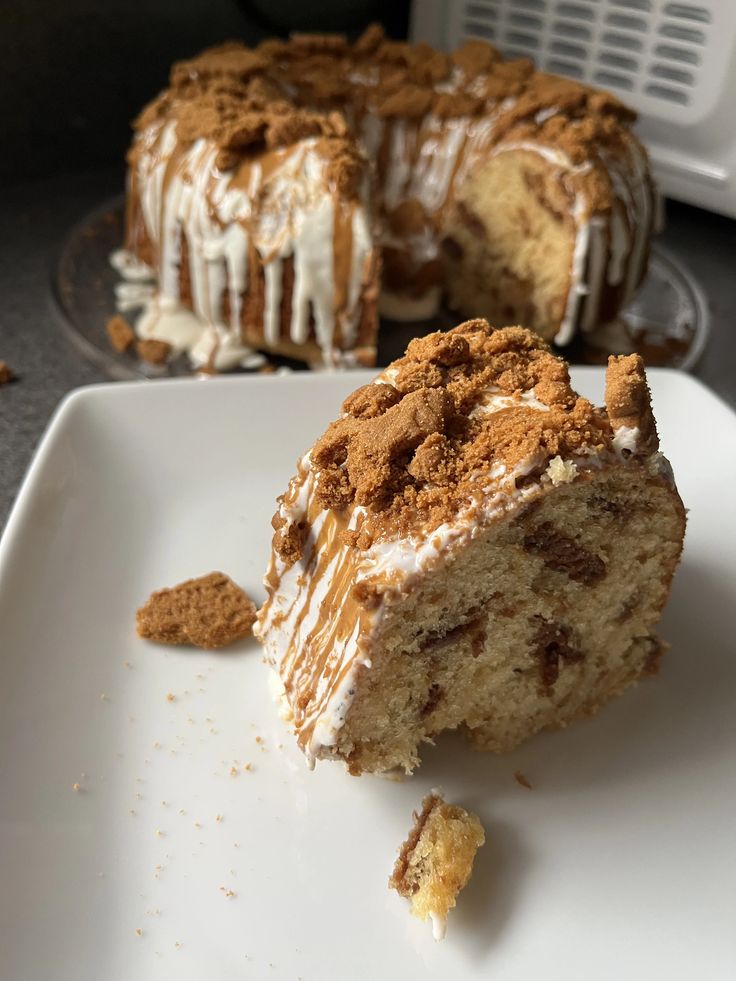 a piece of cake on a white plate with a bite taken out of the cake