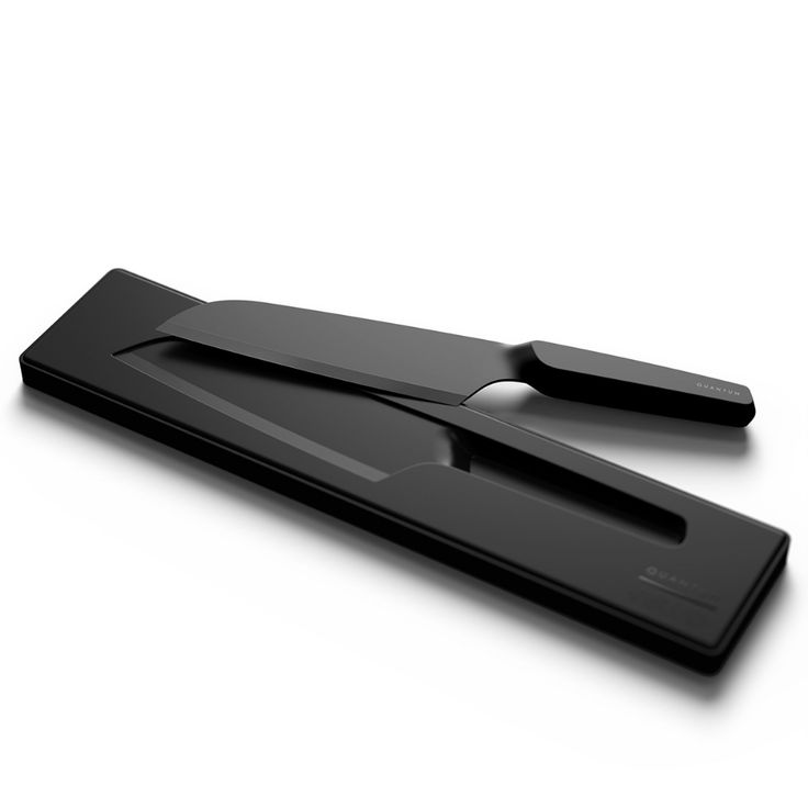 a pair of scissors sitting on top of a black cutting board next to each other