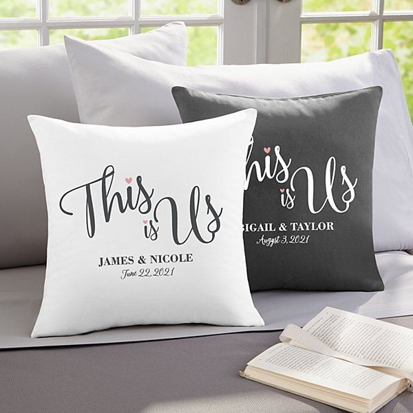 two personalized pillows on a bed with an open book