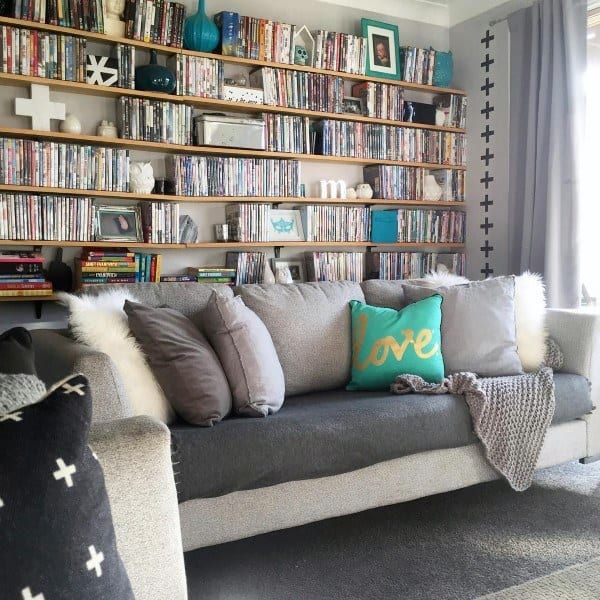 a living room filled with lots of furniture and bookshelves