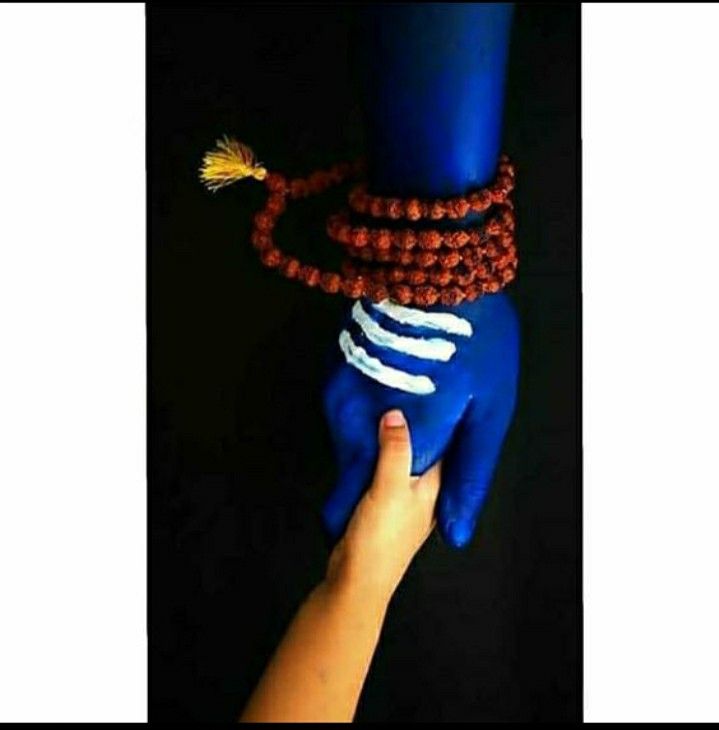 a hand is holding onto a bracelet with beads and tassels on it's wrist