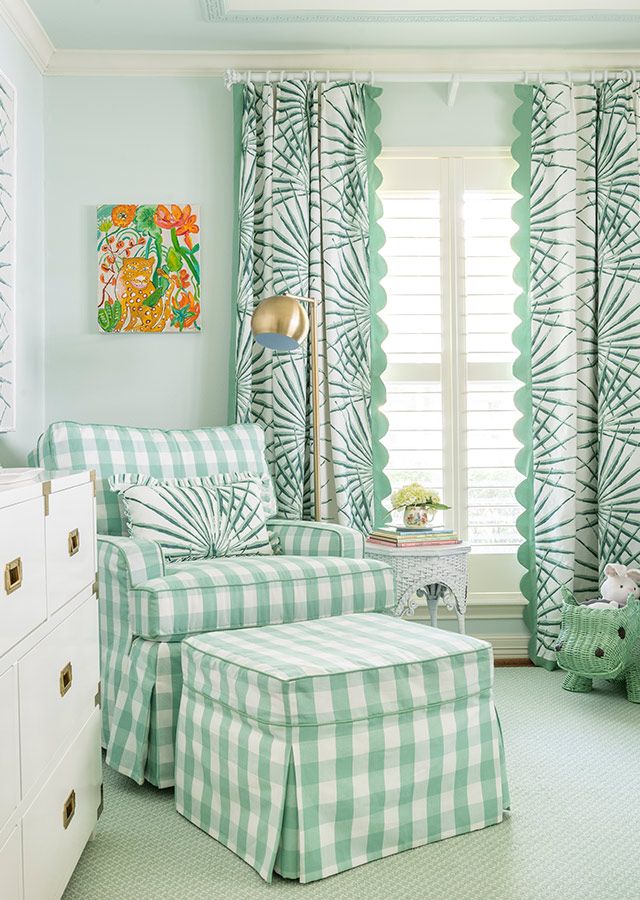 a green and white bedroom with checkered bedspread