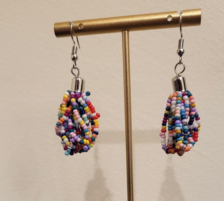 Handmade earrings using interesting designs/beads! Don't hesitate to message us with any questions. Thanks! Trendy Handmade Multicolor Beaded Earrings, Trendy Adjustable Beaded Earrings With Dangling Beads, Trendy Earrings With Colorful Beads, Trendy Earrings With Round Beads And Ear Wire, Colorful Beaded Round Clip-on Earrings As Gift, Colorful Beaded Round Clip-on Earrings For Gift, Multicolor Beaded Clip-on Earrings For Gift, Multicolor Beaded Drop Clip-on Earrings, Handmade Multicolor Dangle Clip-on Earrings