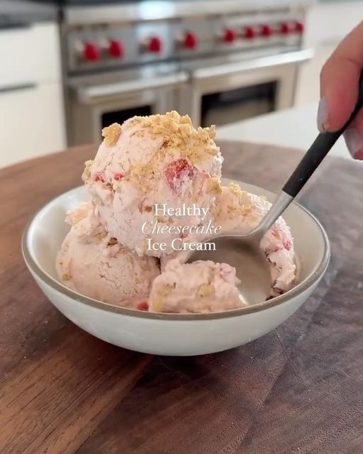 a person is cutting into some ice cream