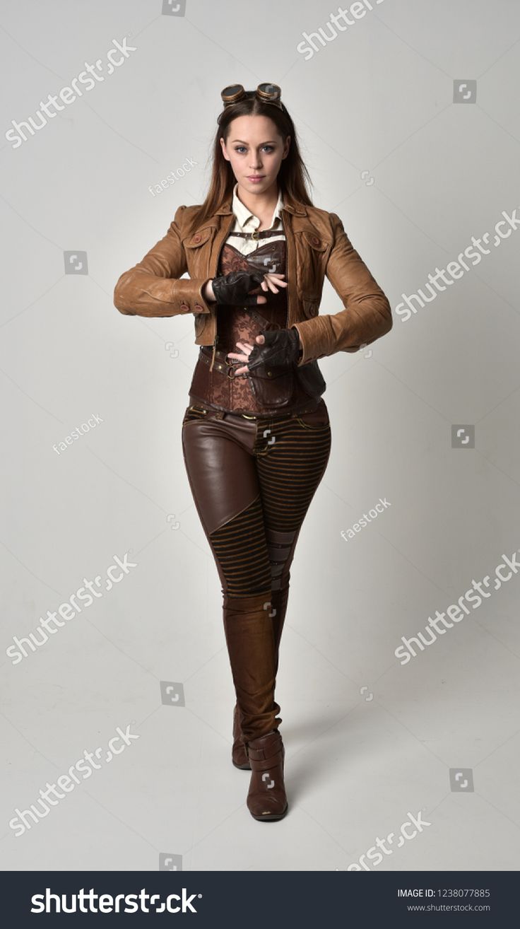 a woman dressed in steam punk clothing posing for the camera with her hands on her hips