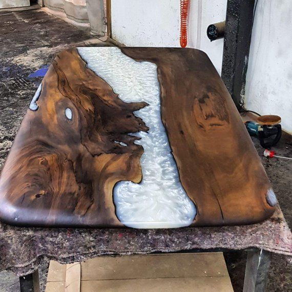 a wooden table with white and brown paint on it