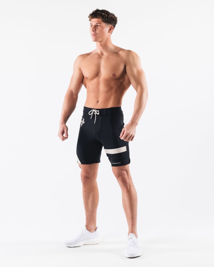 HIGHLIGHTS.. Unlined boardshort. 9” inseam Reflective branding at leg opening and back waistband Elastic waistband with adjustable self-tie drawcords Color-blocking panelling Water resistant fabric FIT SUGGESTION. This item runs true to Alphalete’s standard sizing.. Fit is based off of waist size in inches.. If you are between sizes, we recommend sizing up for a relaxed fit.. Eric is 6’2”/188cm, wearing a size 32. MATERIALS AND WASHING DIRECTIONS. 67% Nylon, 23% spandex. Due to the high saturati Black Bottoms With Built-in Shorts For Water Sports, Athleisure Athletic Shorts For Water Sports With Built-in Shorts, Athleisure Athletic Shorts With Built-in Shorts For Water Sports, Sporty Black Swimwear With Built-in Shorts, Training Shorts With Drawstring, Sporty Nylon Swim Trunks For Surfing, Training Drawstring Shorts, Training Shorts With Elastic Side Panels, Black Shorts With Built-in Shorts For Water Sports