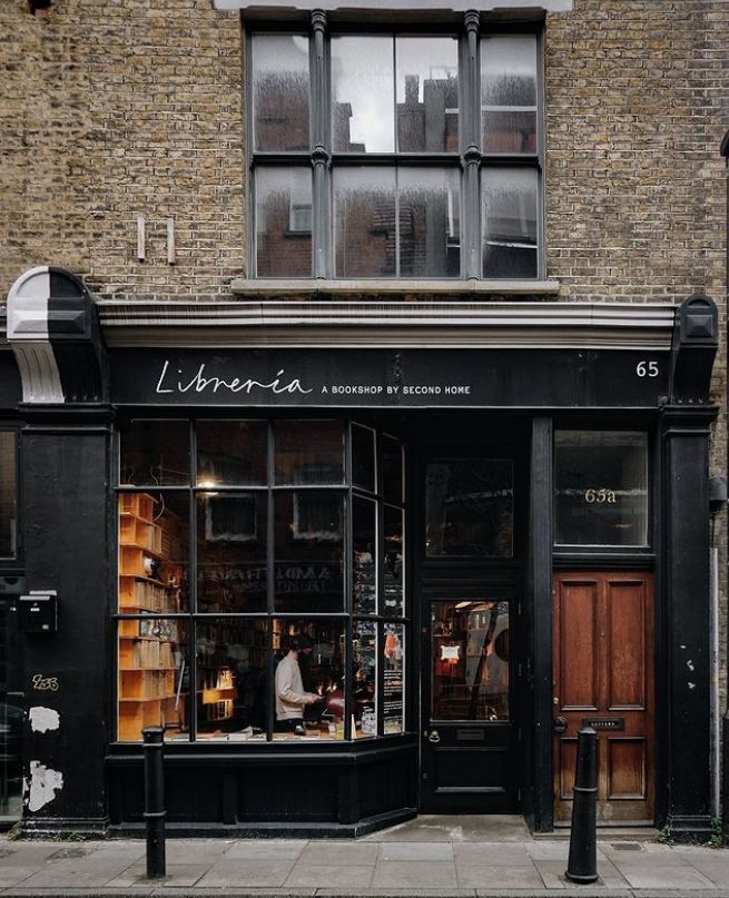 a store front with the door open on a city street corner in london, england