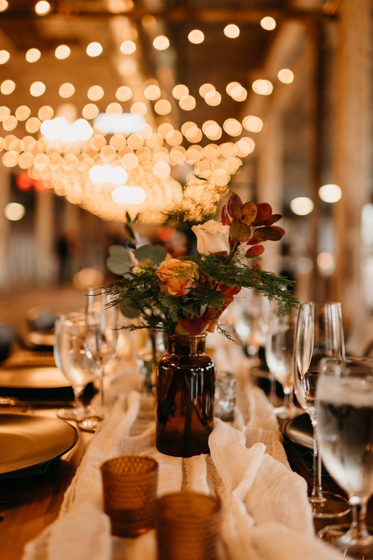 the table is set with wine glasses, plates and utensils for an elegant dinner