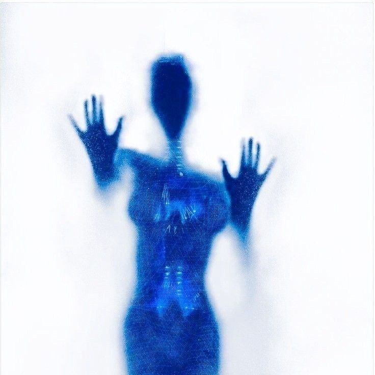 a blurry image of a woman's body with her hands in the air