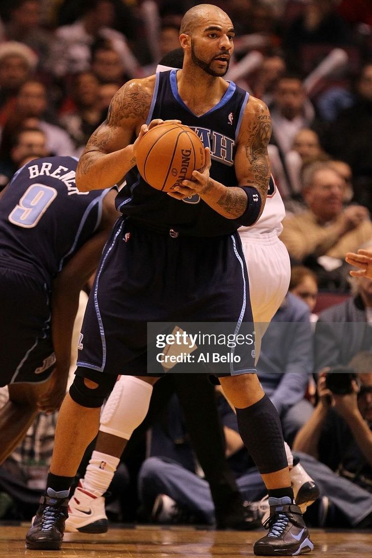 the basketball player is trying to block the ball from being guarded by another player on the court