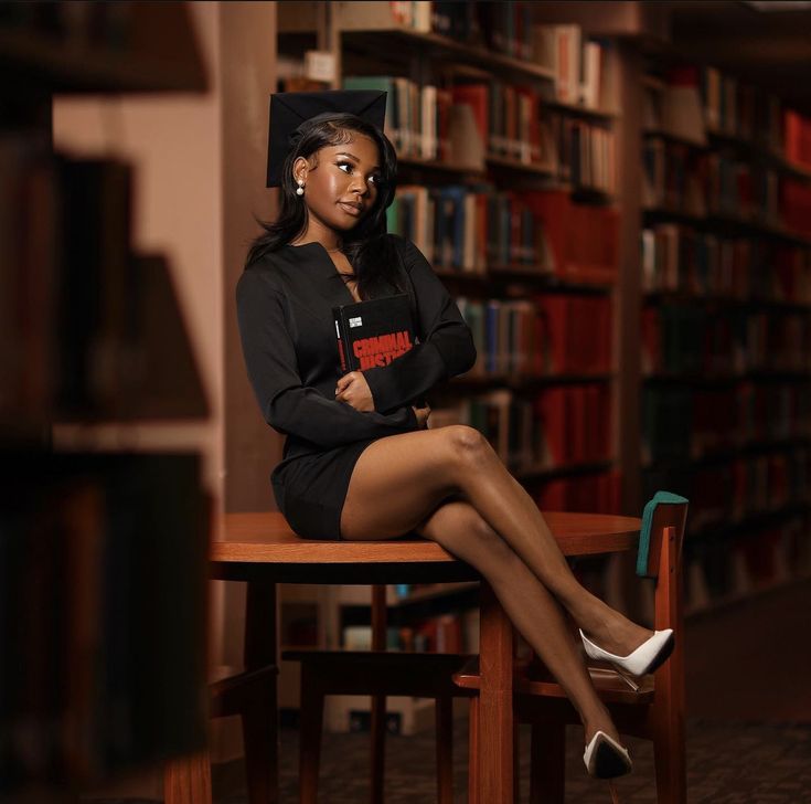 a woman sitting on top of a wooden chair in front of a book shelf filled with books