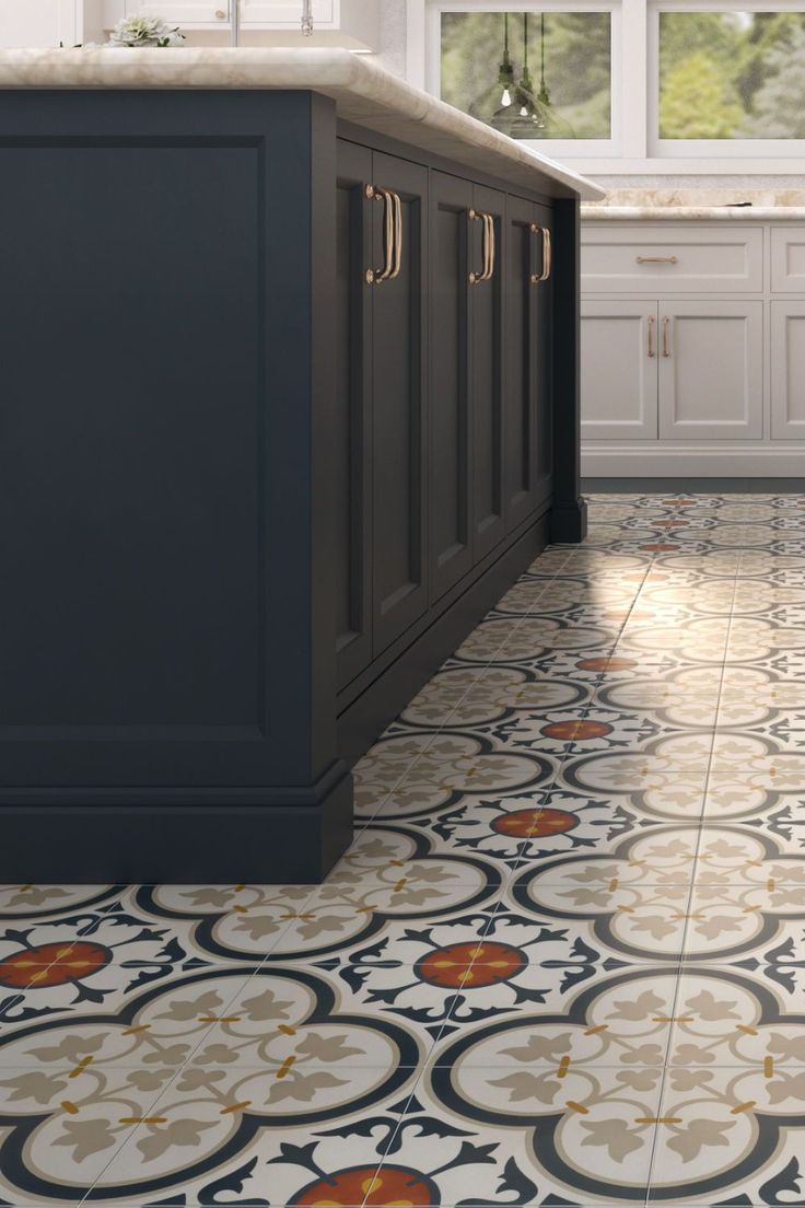 a kitchen with an ornate tile floor and white cabinets