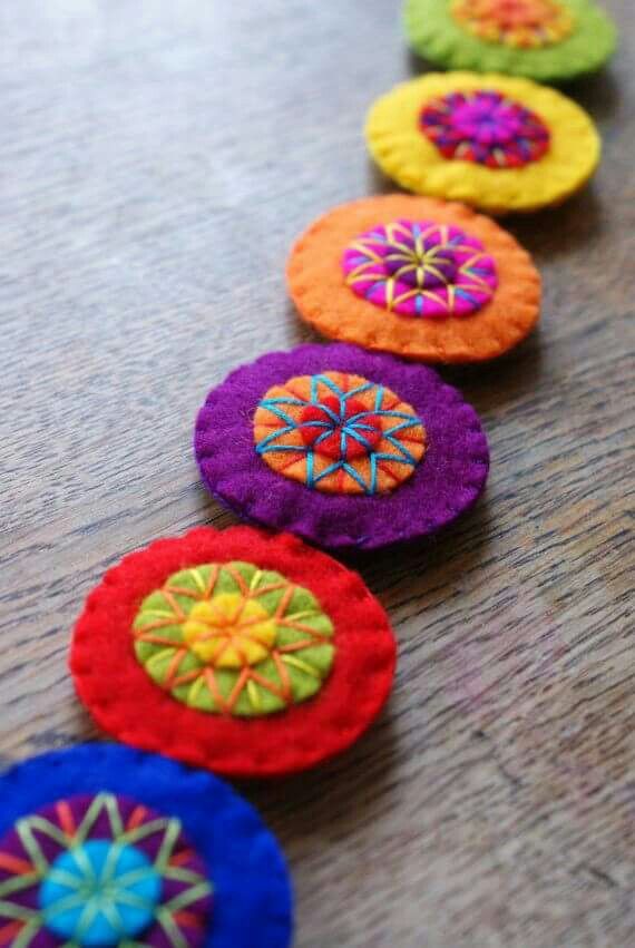 colorful felt flowers are lined up on the table