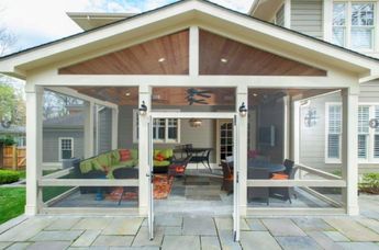 an outdoor living area with glass doors and patio furniture