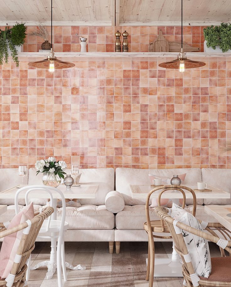 a living room filled with white furniture and lots of pink tiles on the back wall