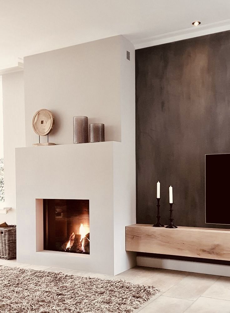 a living room with a fireplace and television