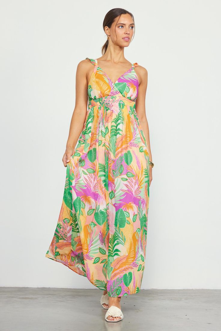 Featuring a long, flowing silhouette that moves gracefully with each step, this maxi dress boasts a sunset-hued tropical print and a surplice-style bodice with pleat detailing. Ruffled straps crisscross the back. A bit of smocking offers a flattering, comfortable fit. •Surplice-style bodice •Ruffled crisscross straps •Pleated waist •Smocked back •Lined Item Number: 99847 100% POLYESTER Spring Tropical V-neck Maxi Dress, Tropical V-neck Maxi Dress With Vibrant Print, Tropical V-neck Maxi Dress For Spring, Tropical Floral Print Maxi Dress With Spaghetti Straps, Tropical V-neck Sundress With Tropical Print, Spring Tropical Maxi Dress With Spaghetti Straps, Tropical Maxi Dress For Spring, Tropical Spaghetti Strap Maxi Dress For Spring, Tropical Maxi Dress With Spaghetti Straps For Spring