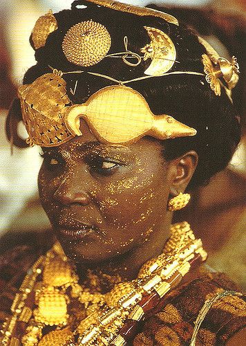 a woman with gold on her face and head