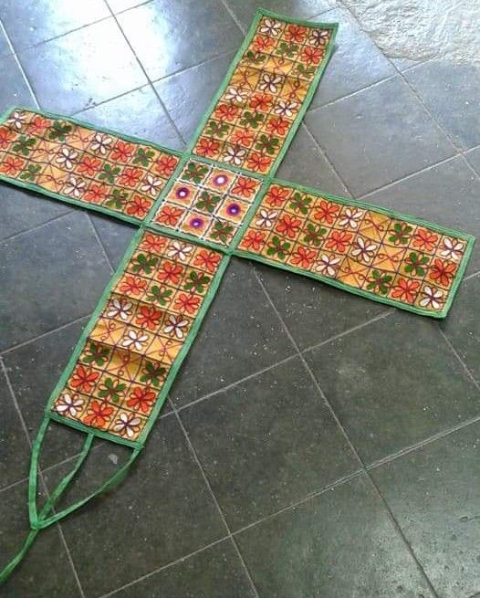 a cross made out of fabric on the floor