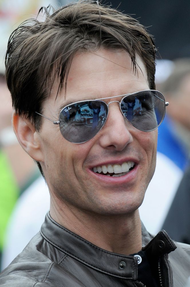 a man wearing sunglasses and smiling at the camera