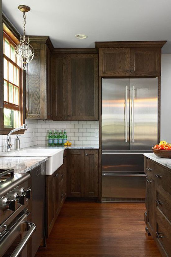 a kitchen with wooden cabinets and stainless steel appliances