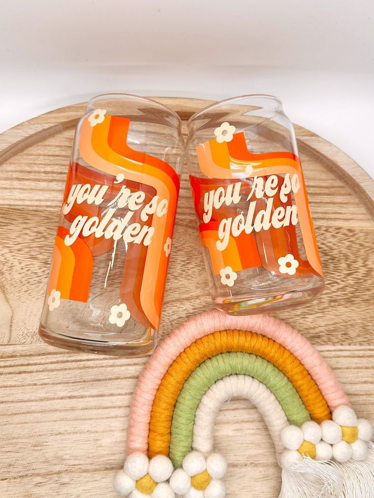 there are two glasses that say you're golden and one has a rainbow on it