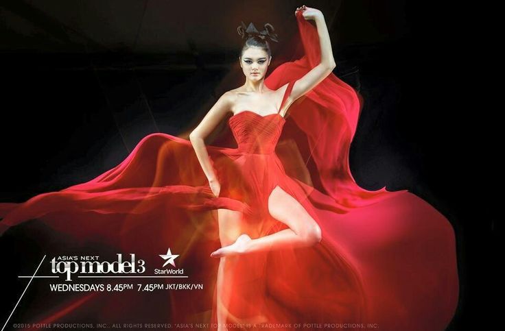 a woman in a red dress is dancing