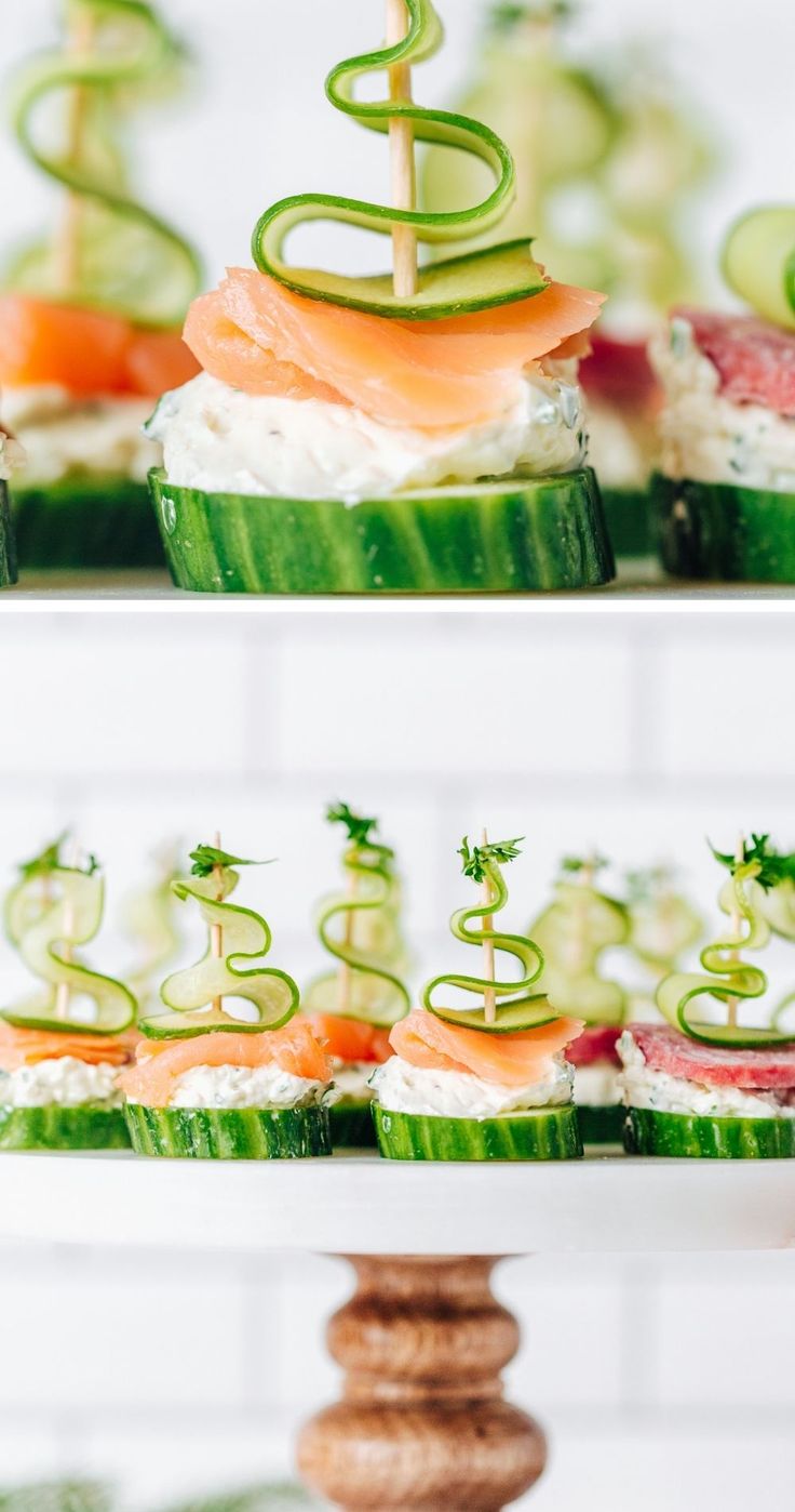 an assortment of sushi and cucumber arranged on three tiered trays