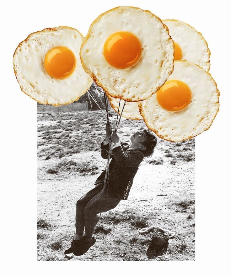 a man holding three fried eggs over his head