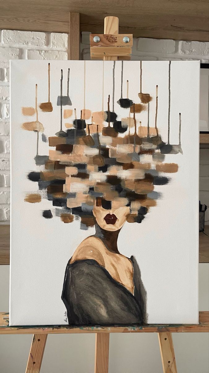 a painting on an easel with a woman's head made out of hanging objects