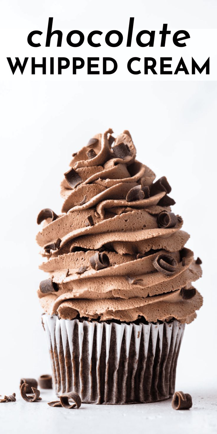 a chocolate whipped cream cupcake on a white surface with the words chocolate whipped cream above it