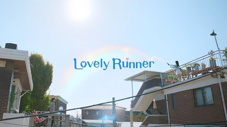 there is a sign that says lovely runner on the side of a building in front of some houses